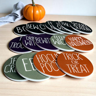 Individual Halloween coaster showing cork backing detail
Halloween party table setting with themed coasters
Close-up of Halloween coaster text and design