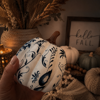 chinoiserie pumpkins styled on kitchen island fall decor
blue white pumpkins home decor styled shelf display
coastal interior fall decor blue white pumpkin accents
blue white pumpkins styled on entryway table fall decor
elegant fall decor blue white pumpkins styled in home