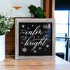 Wooden and metal Christmas sign with black and white, snowflake design, with text that reads all is calm and all is bright quote