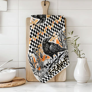 edgy fall kitchen towel with crow skull and checkered border
funny fall tea towel for halloween parties crow design
black bird halloween hand towel with orange grunge background
crow and jack o lantern style skull towel for spooky décor
witchy fall kitchen towel with raven and skull print