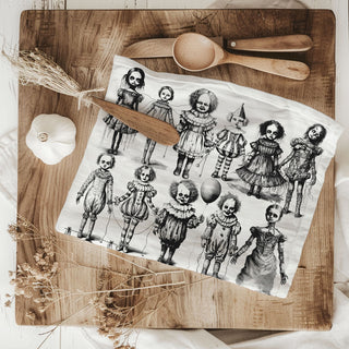 vintage clown and doll halloween dish towel on cutting board
gothic halloween kitchen towel with spooky dolls and clowns
halloween hand towel with creepy vintage dolls