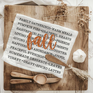fall phrases towel draped on oven for seasonal décor
autumn kitchen textile with word art and fall script
fall-themed dish towel perfect for thanksgiving gift basket