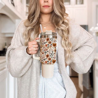 neutral aesthetic handled cup
fall tumbler for moms
autumn botanical tumbler
cozy floral travel mug
floral leaf tumbler design
minimal floral autumn tumbler
fall coffee tumbler aesthetic
cute seasonal floral cup
warm toned floral tumbler