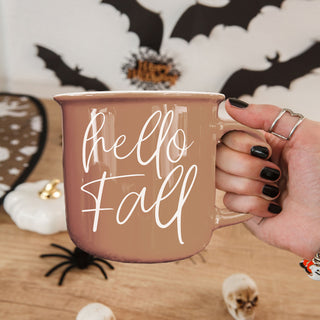 hello fall coffee mug with neutral fall decor
hello fall mug next to carved pumpkin and lantern
hello fall coffee mug held in hands
hello fall mug close up product shot
hello fall autumn mug with cozy candle wholesalers