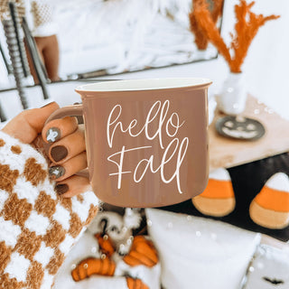 hello fall script mug with dried florals
hello fall mug beside rustic fall centerpiece
hello fall coffee mug with open book and glasses
hello fall mug on couch with knit blanket