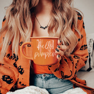 orange mug with steam and fall decor
fall hot drink mug with pumpkins and leaves
rustic orange coffee mug on wooden tray
pumpkin colored mug for cozy nights in