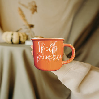 hello pumpkin mug on bed with blankets and pillows
hello pumpkin mug paired with fall wall art
hello pumpkin coffee cup with manicured nails
