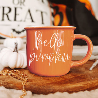fall coffee mug styled with chunky knit cardigan
hello pumpkin mug for cozy sweater weather mornings
autumn coffee cup in warm orange color