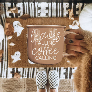 leaves falling coffee calling mug on marble countertop
autumn coffee cup with warm brown tones and fall decor
brown fall mug with chain and pumpkin styling
leaves falling coffee calling mug for fall coffee bar