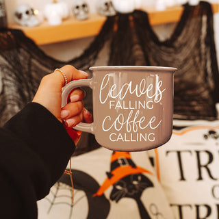 brown fall coffee cup on marble with scattered leaves
leaves falling coffee calling mug for fall hostess gift
autumn breakfast spread with brown coffee mug and pastries
brown fall mug next to coffee beans and pumpkin decor