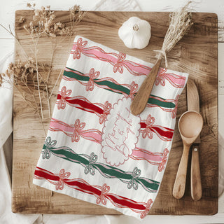 festive pink christmas towel with merry bright wording
holiday towel with bow accents for cozy kitchen styling
christmas kitchen towel aesthetic with ribbon design
gift idea christmas towel with bow pattern for hostess
seasonal kitchen towel with festive ribbon bow design