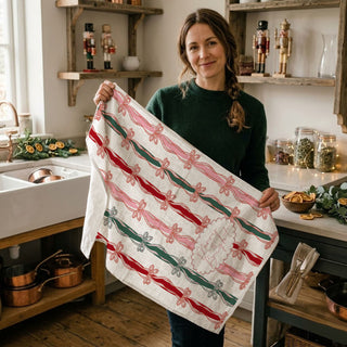 christmas kitchen towel with festive ribbon bow stripe pattern
merry and bright holiday dish towel pink red green ribbon design
holiday hand towel with bow print farmhouse christmas kitchen decor
festive christmas towel with vertical ribbon stripes and bows
pink holiday kitchen towel with bow accents and script lettering