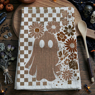 boho fall kitchen towel with skull, flowers and checkerboard
vintage skull and ghost tea towel hanging on oven handle
neutral spooky season towel for minimalist halloween décor