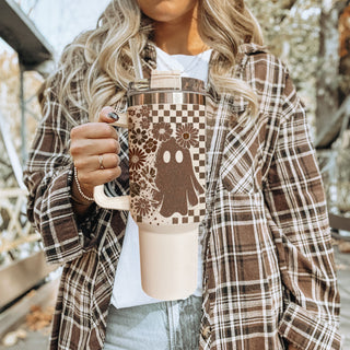 Retro spooky tumbler with checkered pattern and flowers

40oz fall tumbler with ghost, skull, and floral design

Neutral autumn tumbler with vintage checkered wrap

Cute spooky 40oz insulated tumbler for fall

Retro Halloween tumbler with ghost and skull artwork