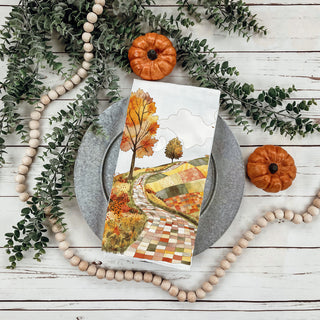 autumn kitchen hand towel with scenic countryside illustration
fall road landscape towel styled with rosemary and spoon
cozy autumn trail dish towel for pumpkin spice lovers
whimsical fall path kitchen towel for storybook décor
