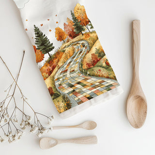 cozy farmhouse fall kitchen towel with winding path design
autumn trees and checkered road dish towel on cutting board
storybook fall road cotton towel for thanksgiving kitchen
rustic fall landscape towel for farmhouse autumn décor