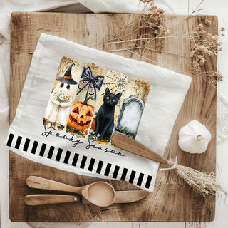 spooky season bar cart towel with jack o lantern
ghost and tombstone halloween towel for gothic kitchen
minimal spooky season towel with striped border
trendy halloween kitchen towel for october baking