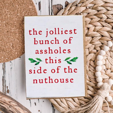 The Jolliest bunch of assholes this side of the nuthouse sign