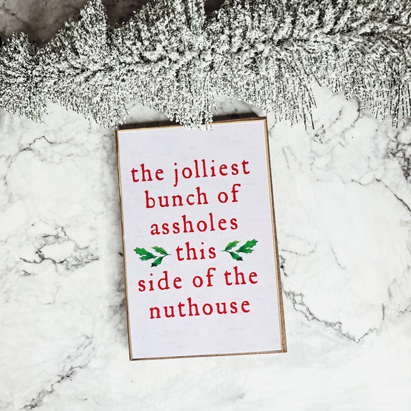The jolliest bunch of assholes this side of the nuthouse wooden block sign